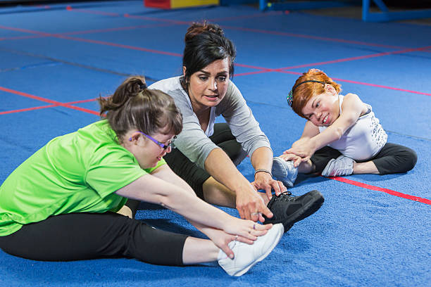 istock Fitness instructor working with special needs women 541586042