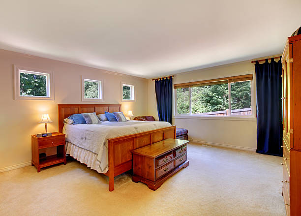 istock Bedroom interior with beige carpet floor and dark blue curtains. 541589088