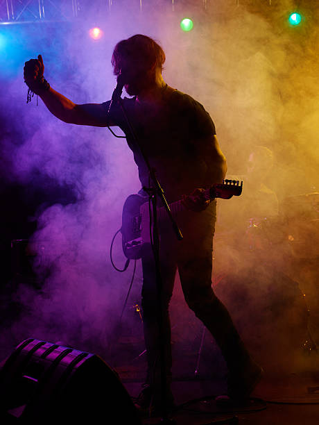 istock Silhouette of guitar player on stage. 541589326