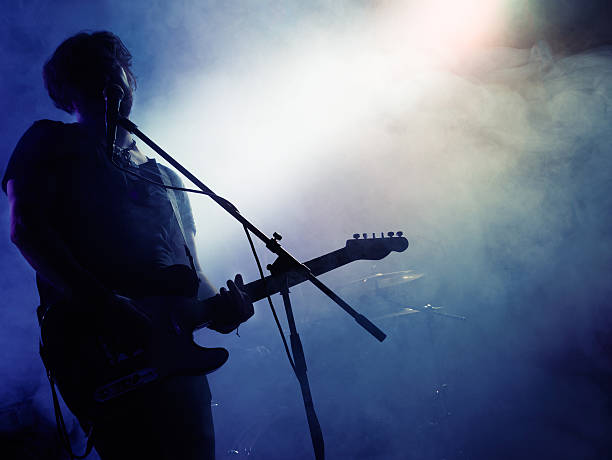 istock Silhouette of guitar player on stage. 541590130