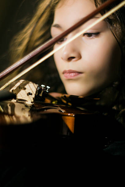 istock Little Girl Playing the Violin 541590500