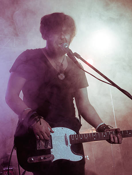 istock Silhouette of guitar player on stage. 541591250