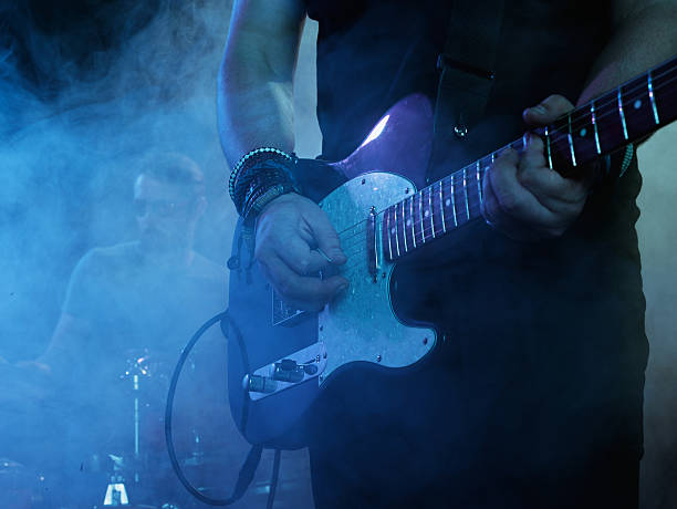 istock Silhouette of guitar player on stage. 541591816