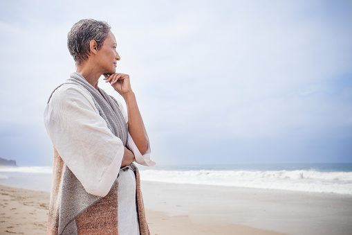 A senior African American woman relaxing on the beach