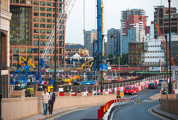 London, UK - September 17, 2015: Building sites with cranes at Canary Wharf, quickly growing business and residential aria in London