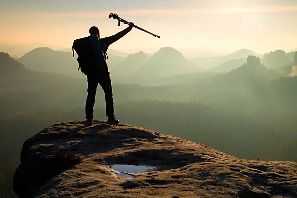 istock Hiker with broken leg in immobilizer. Deep valley bellow silhouette 541599346