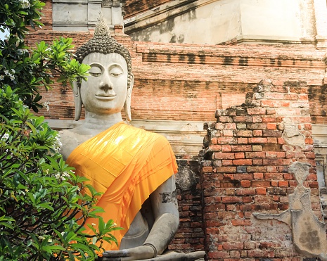 Old Buddha statue in front of the old castle in Ayutthaya,Thailand.  Ancient Buddha hundreds of years ago.