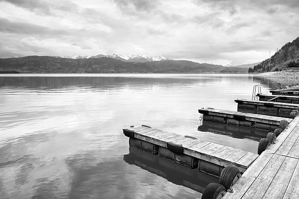 istock Empty wooden mole on  blue Alps lake, wharf for boats 541599634