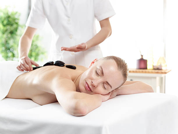 istock Young woman having volcanic stone therapy 541599738