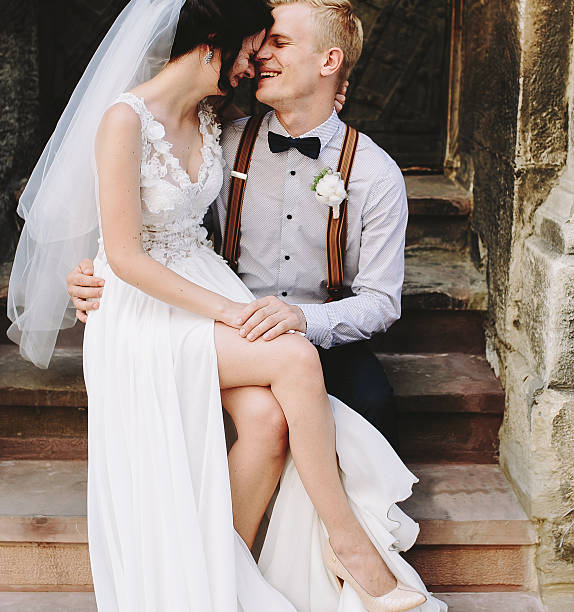 istock Bride sitting on lap of the groom 541600696