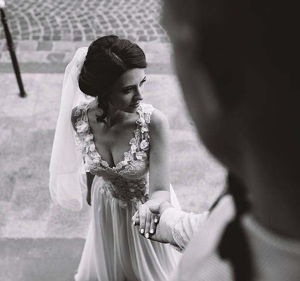 istock Groom holds hand of the bride 541600856