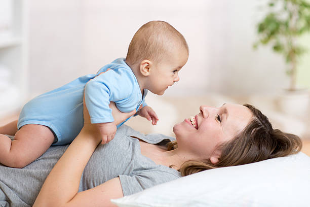 istock smiling mother and her child lying on the bed 541601678