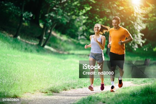 istock Healthy couple jogging in nature 541602804