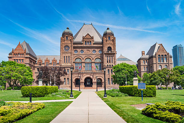 Ontario Legislative Building at Queens Park in Toronto Ontario Canada Photo of the facade of the landmark  Ontario Legislative Building at Queen's Park in Toronto, Ontario, Canada on a blue sky day. The Ontario Legislative Building is a public building which houses the Legislative Assembly of the province of Ontario. toronto stock pictures, royalty-free photos & images
