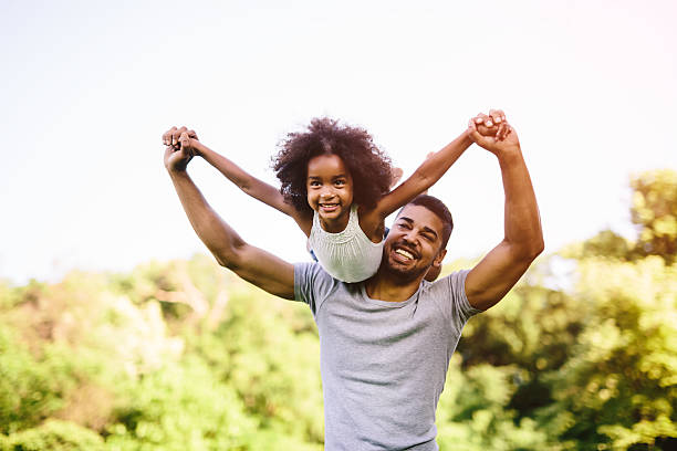 istock Child flying on father shoulders 541604636