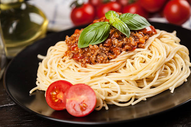 istock Spaghetti bolognese on dark background 541605322
