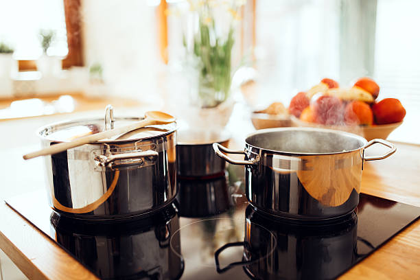 Lunch being made in modern kitchen Organic lunch being made in modern kitchen pan stock pictures, royalty-free photos & images