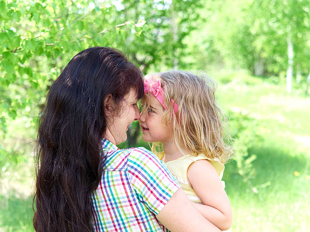 istock mother playing with her  little daughter on nature 541607926