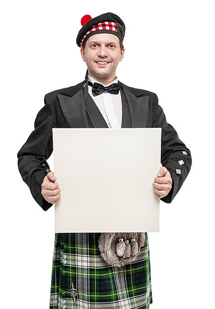 istock Scottish man in traditional national costume with empty banner 541609448