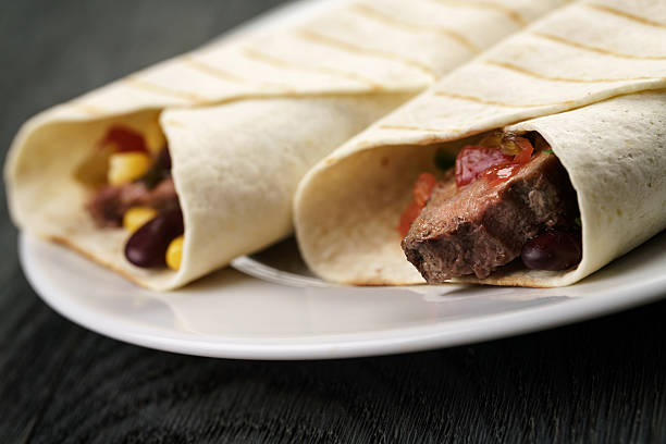 istock burritos with beef steak, corn, black beans and salsa sauce 541609638