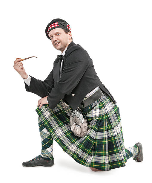 istock Scottish man in traditional costume with smoking pipe 541609802