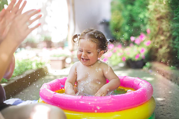 istock one year old baby playing in baby pool 541823854