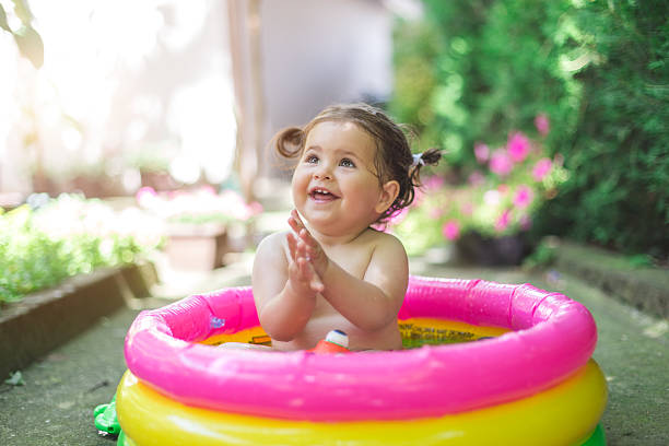 istock one year old baby playing in baby pool 541823860