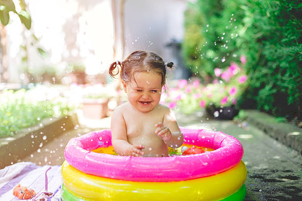 istock one year old baby playing in baby pool 541823960