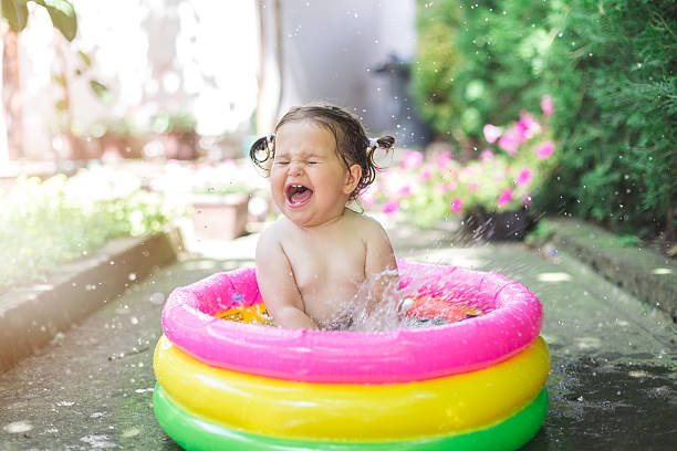 istock one year old baby playing in baby pool 541824838