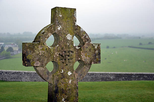istock celtic cross on the graveyard and nature landscape 541825664