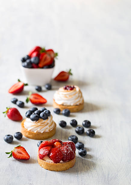 Fresh berry tarts with strawberry and blueberry Fresh berry tarts with strawberry and blueberry tart dessert stock pictures, royalty-free photos & images