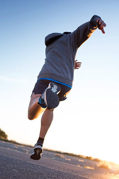 istock Young man running in the street. 541829172