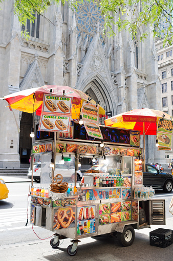 New York, United States - June 19, 2016: NYC Street food Cart set up on 5th Avenue across the street from St. Patricks Cathedral ready to service New Yorkers for quick lunch. 