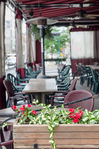 Outdoor restaurant patio Sherbrooke, Canada - June 11, 2016: Outdoor restaurant patio with plastic chairs and flowers with foreground focus. sherbrooke quebec stock pictures, royalty-free photos & images