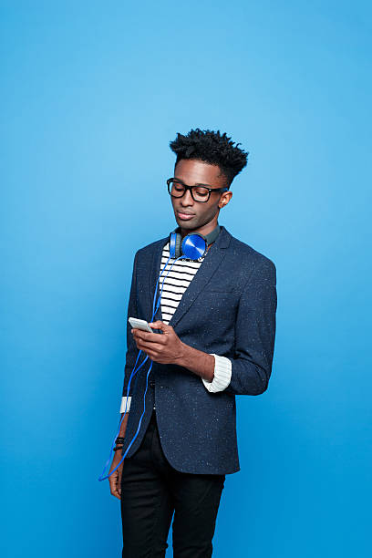 istock Afro american guy in fashionable outfit using smart phone 541833154