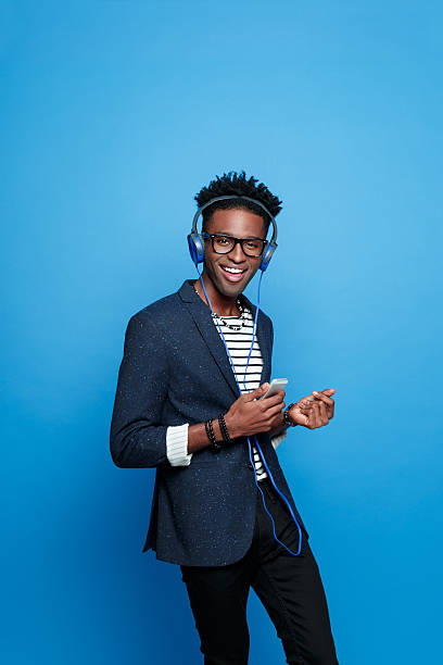 istock Afro american guy wearing headphone using smart phone 541833228