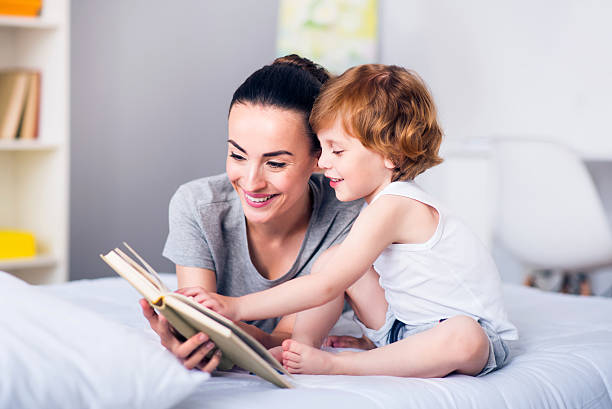 istock Mother and child reading a book 541834682