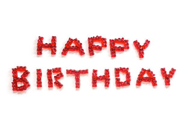 istock Happy Birthday, letters from red gummy bears on white 541834814