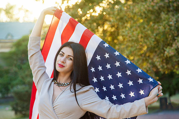 istock American flag and woman (4th july) 541835004