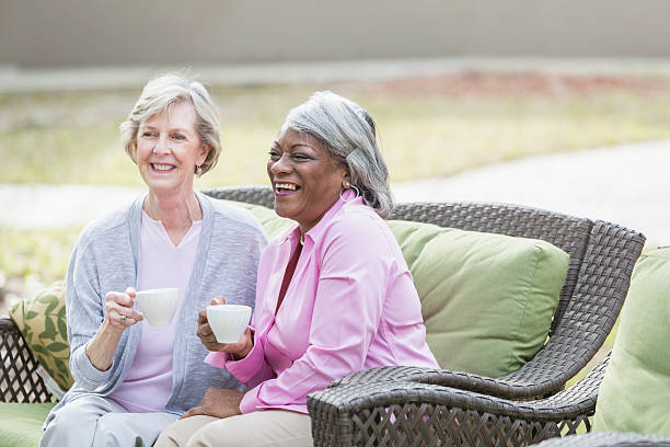 istock Two multiracial senior women having tea outdoors 541835820