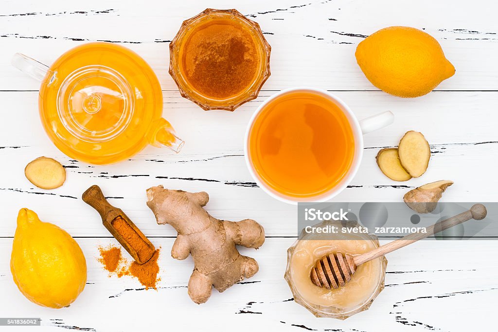 Detox hot lemon water with ginger, cayenne, turmeric and honey Hot lemon water with ginger, cayenne, turmeric and honey. Detox liver fat burnner, immune boosting, anti inflammatory healthy drink Gold Colored Stock Photo