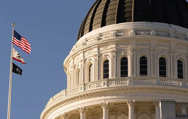 The flags fly in front of Sacramento's Capital Building