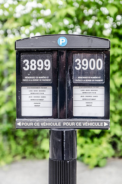 Parking sign with space number and operating hours Dual parking sign with space number and operating hours, all in french sherbrooke quebec stock pictures, royalty-free photos & images