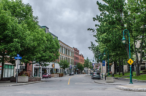 Wellington North street in Sherbrooke at corner of Frontenac Sherbrooke, Canada - June 11, 2016: Wellington North street in Sherbrooke at corner of Frontenac. This is downtown during a cloudy day of sprintime early in the morning when the city is just starting to wake up. sherbrooke quebec stock pictures, royalty-free photos & images