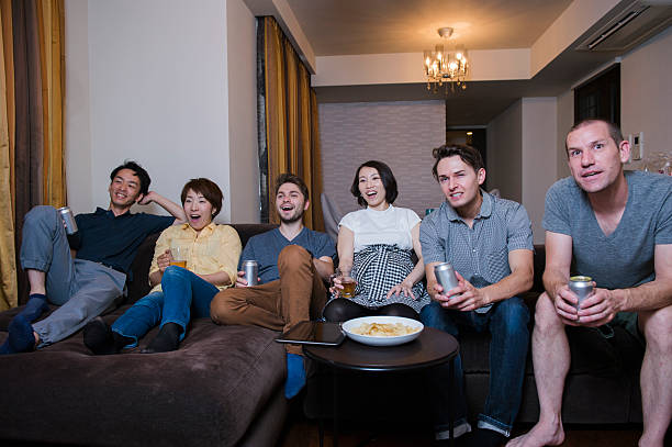 istock Group of friends watching TV match and cheering 541842036