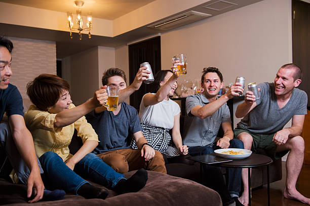istock Six friends drinking beer at home 541842214