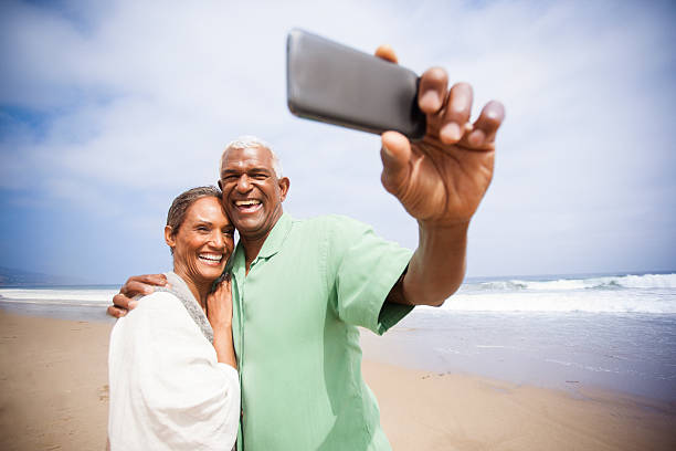 istock African American Seniors Taking Selfie Together on Beach 541842306