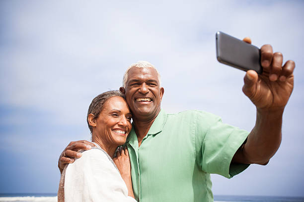 istock African American Seniors Taking Selfie Together on Beach 541842320