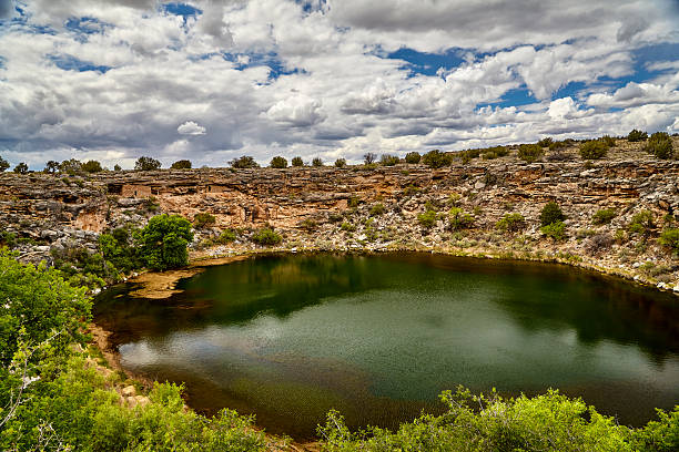 Montezuma's Well Camp Verde  Arizona Natural sink hole in limestone in the American southwest used by the ancient Sinagua with cliff dwellings in the side of the cliff surrounding the water puebloan peoples stock pictures, royalty-free photos & images