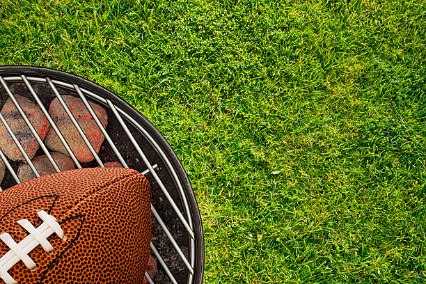 Football Tailgate BBQ Grill on Grass Football Tailgate BBQ Grill on Grass tailgate party photos stock pictures, royalty-free photos & images